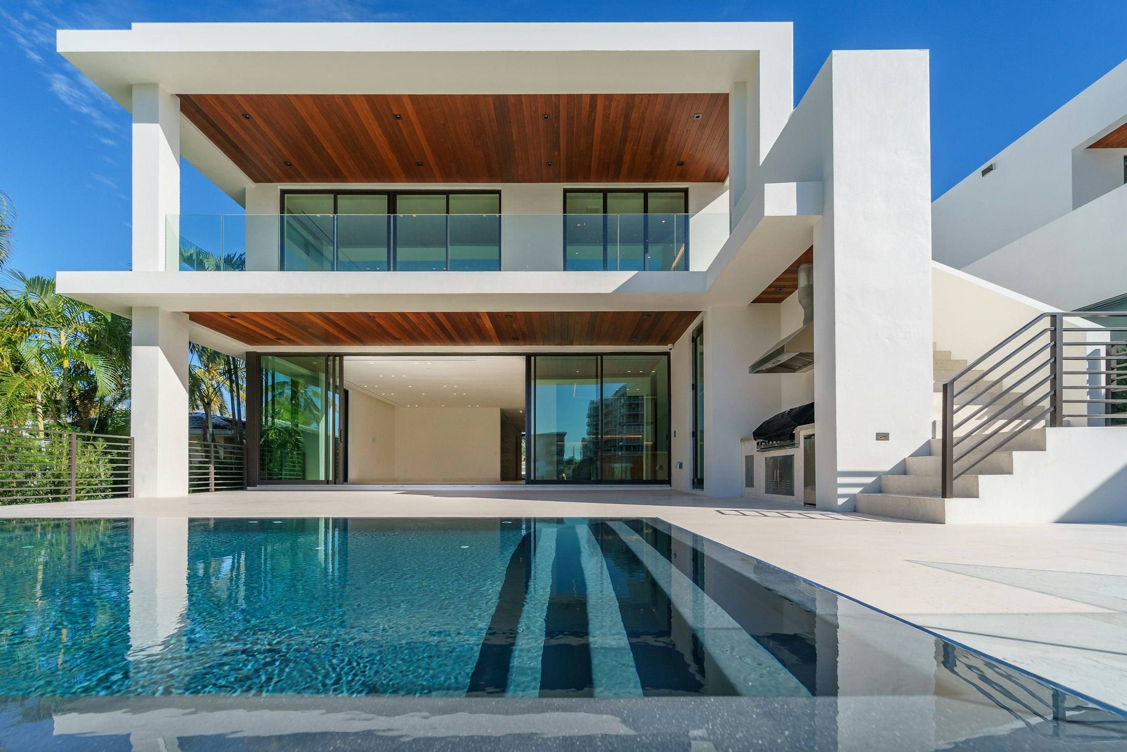 White modern Arizona home with a long reflecting pool in the foreground